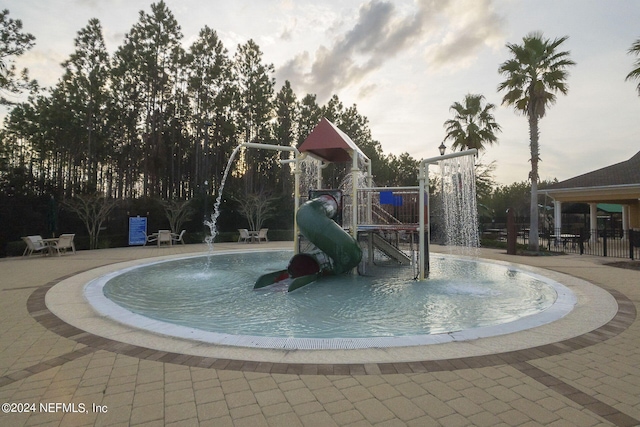 view of swimming pool with a playground