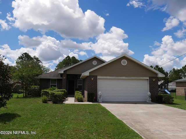 ranch-style house featuring a garage and a front lawn