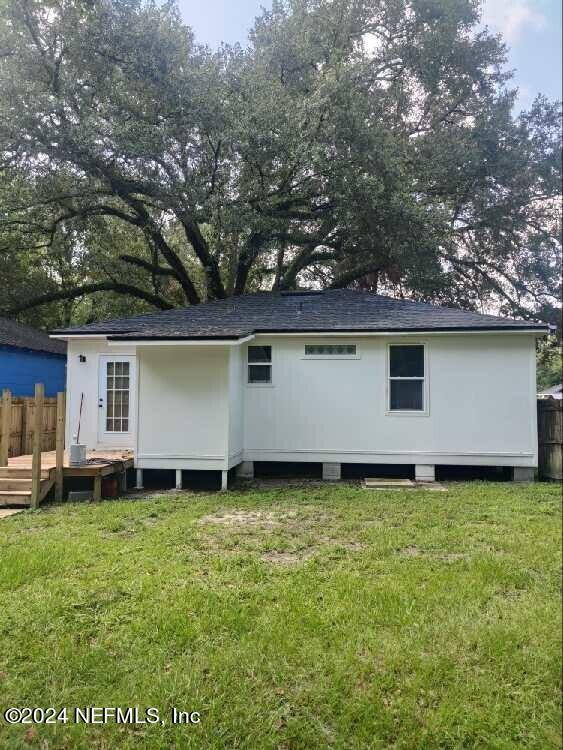 back of house with a yard