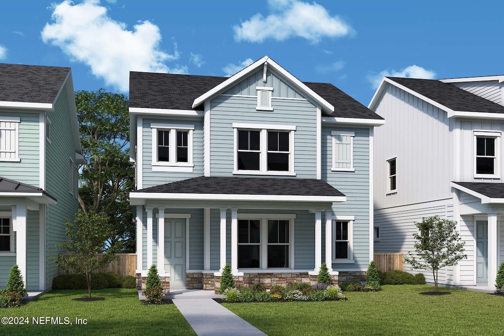 view of front of house with a front yard and covered porch