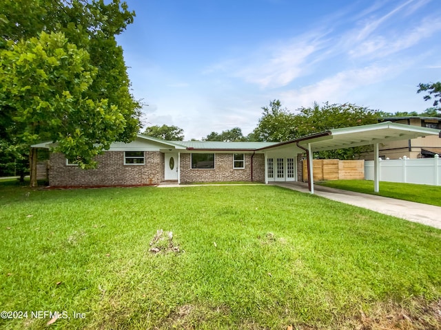 ranch-style home featuring a carport, french doors, and a front yard