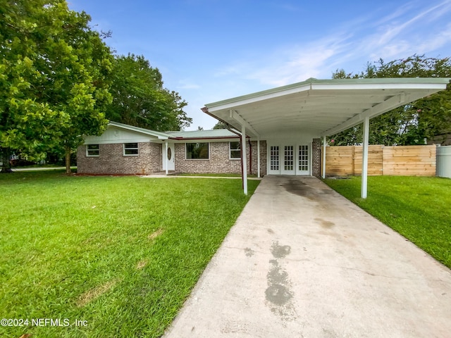 view of front of house with a front yard and french doors