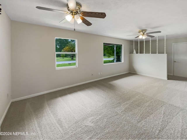 carpeted spare room with ceiling fan