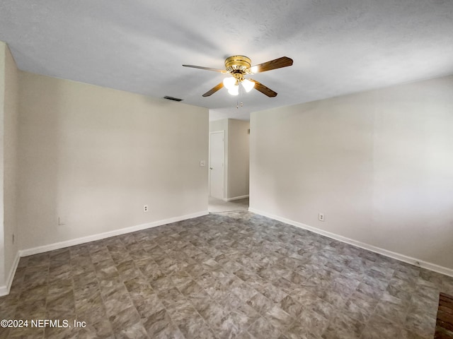 spare room with ceiling fan