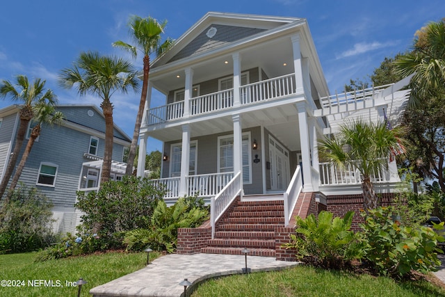 view of front of property featuring a balcony and a porch