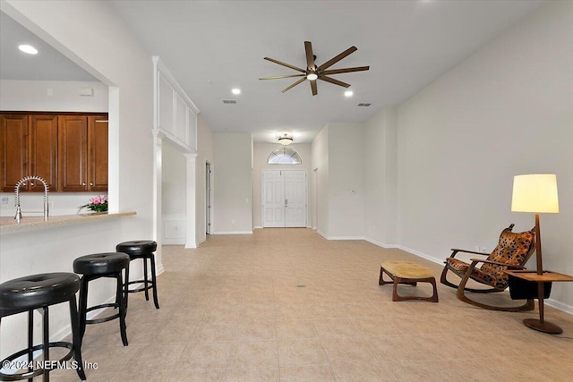 sitting room with ceiling fan, light tile patterned floors, and sink