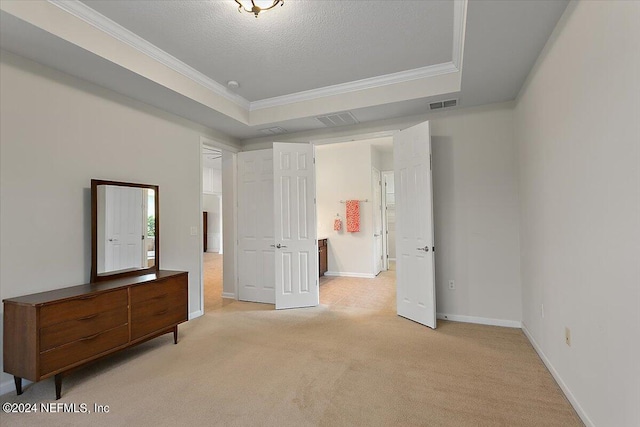 bedroom with a raised ceiling, light colored carpet, a textured ceiling, and ornamental molding