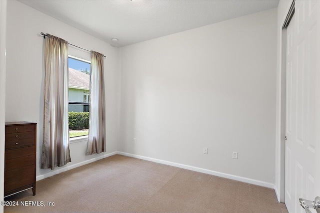 unfurnished bedroom with light carpet