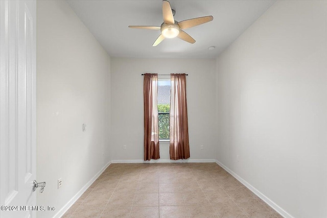 tiled empty room with ceiling fan