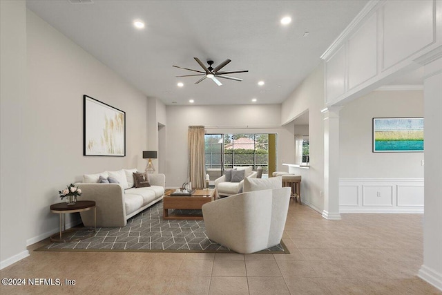 tiled living room featuring decorative columns and ceiling fan