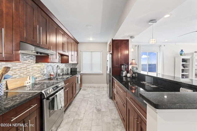 kitchen with pendant lighting, dark stone countertops, appliances with stainless steel finishes, and tasteful backsplash