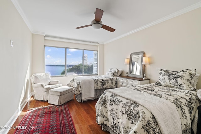 bedroom with a water view, ceiling fan, crown molding, and dark hardwood / wood-style floors