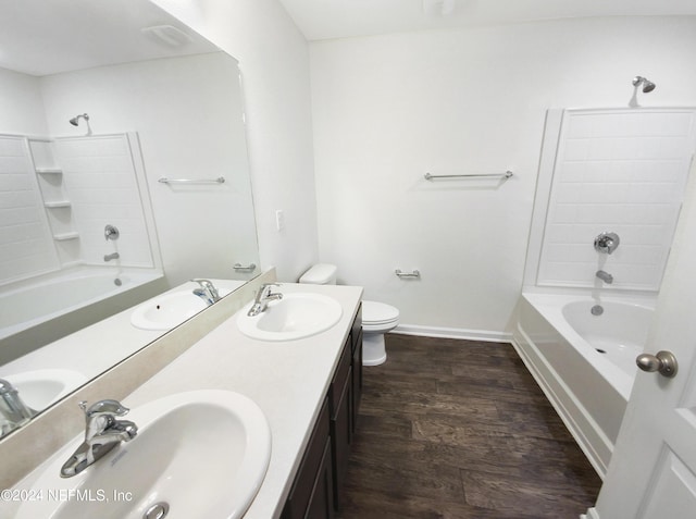 full bathroom with hardwood / wood-style floors, toilet, vanity, and shower / bathing tub combination