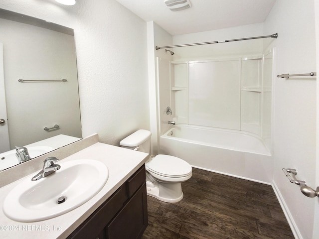 full bathroom with wood-type flooring, toilet, vanity, and  shower combination