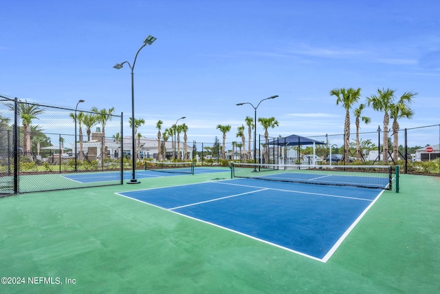 view of tennis court with basketball hoop