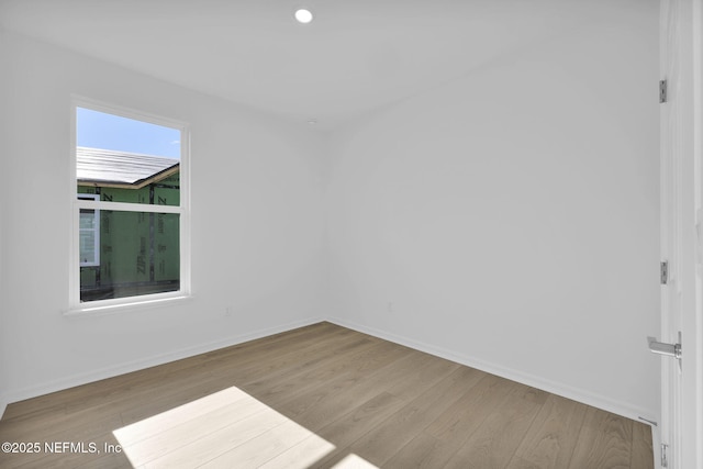 spare room featuring light hardwood / wood-style flooring