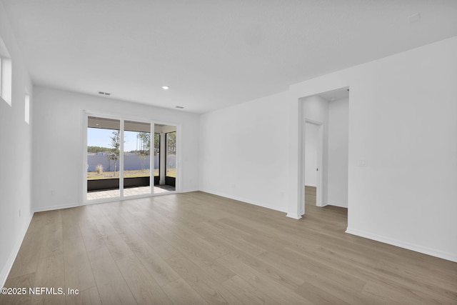 spare room featuring light wood-type flooring