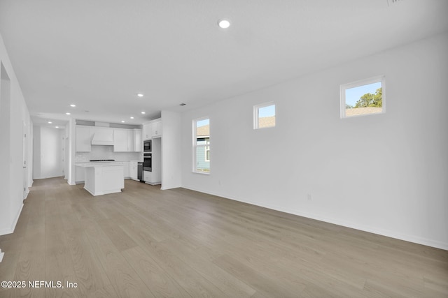 unfurnished living room featuring light hardwood / wood-style floors