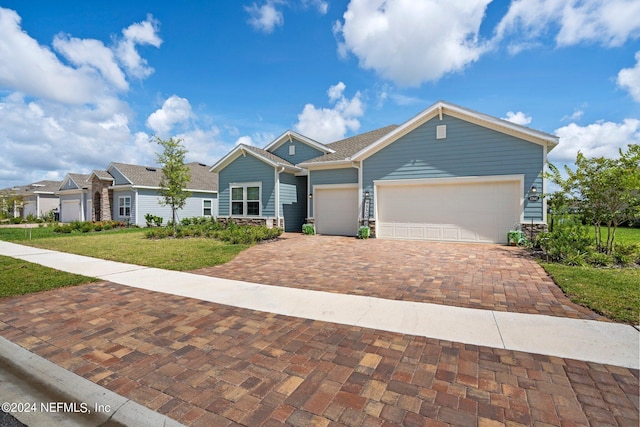 view of front of home with a garage and a front lawn