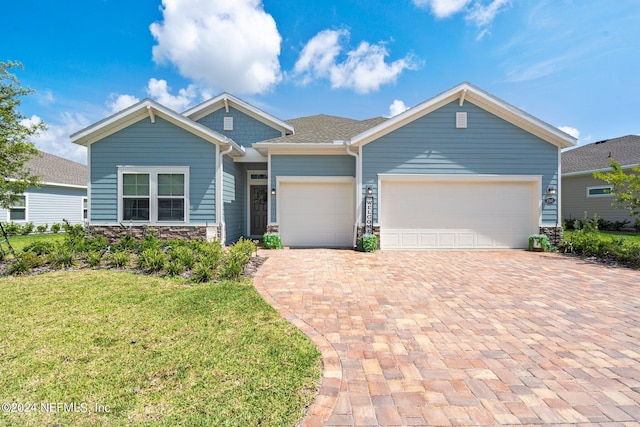 view of front of home with a front lawn and a garage