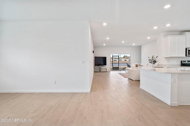 kitchen featuring white cabinetry, light hardwood / wood-style flooring, and sink