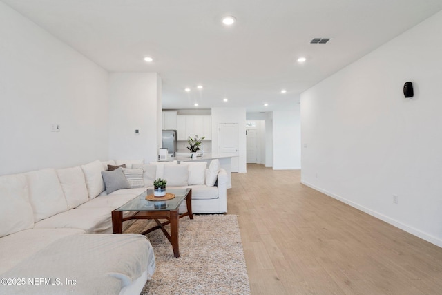 living room with light hardwood / wood-style flooring