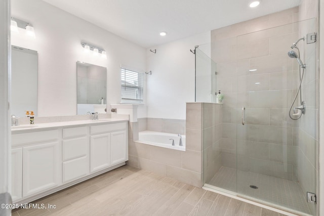 bathroom featuring vanity and plus walk in shower