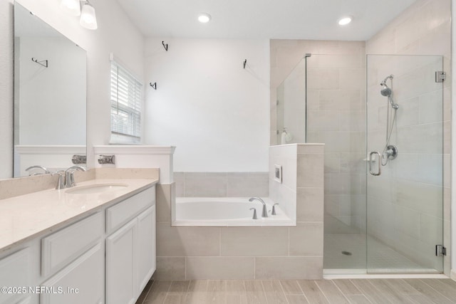 bathroom with plus walk in shower and vanity