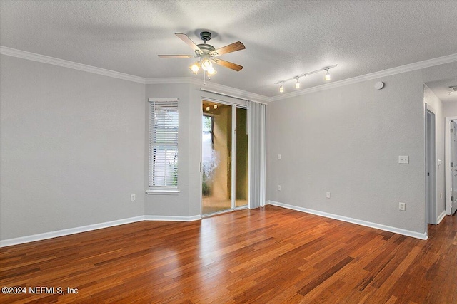 unfurnished room featuring crown molding, a textured ceiling, baseboards, and wood finished floors