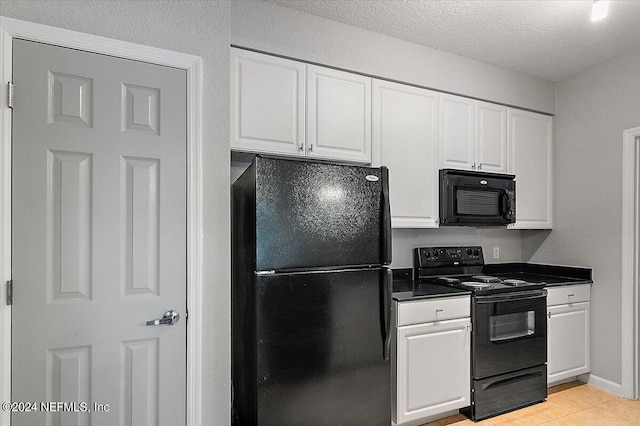 kitchen with dark countertops, white cabinetry, a textured ceiling, and black appliances