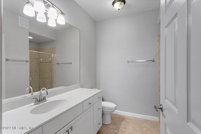 bathroom featuring a stall shower, baseboards, visible vents, toilet, and tile patterned floors