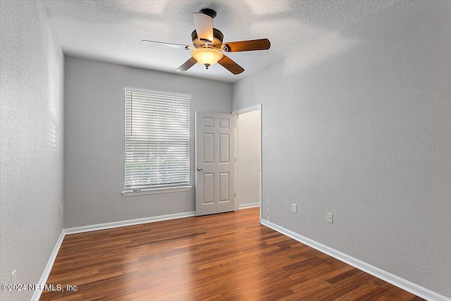 unfurnished room with baseboards and wood finished floors