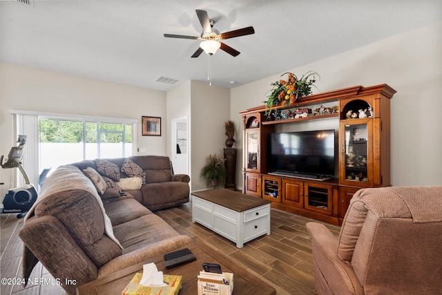 living room with dark wood-type flooring and ceiling fan