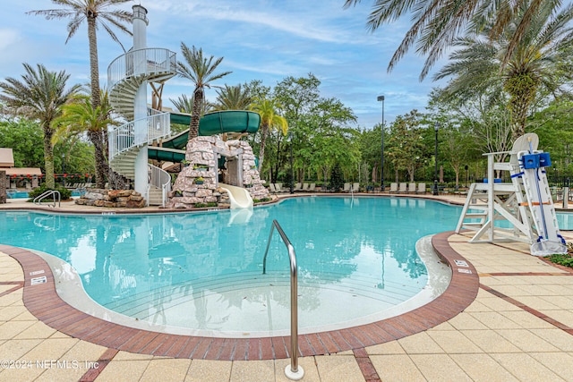 view of swimming pool with a water slide