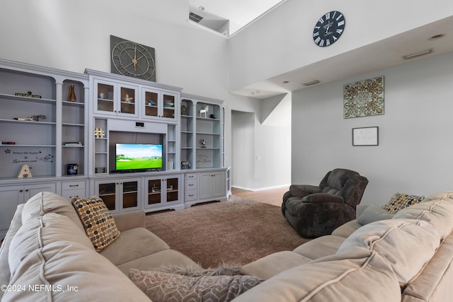 living room featuring a towering ceiling