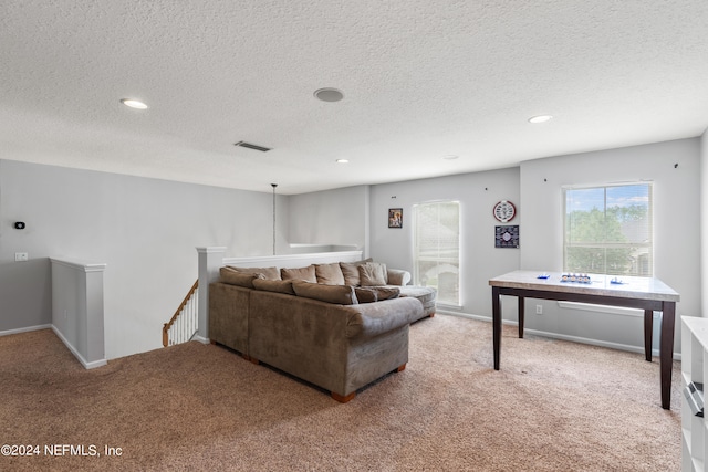 carpeted living room with a textured ceiling