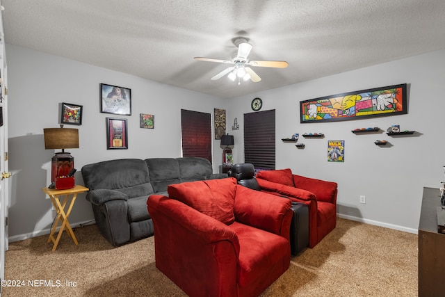 living room featuring ceiling fan, carpet floors, and a textured ceiling