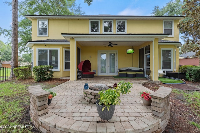 back of house with an outdoor fire pit, a patio area, ceiling fan, and french doors