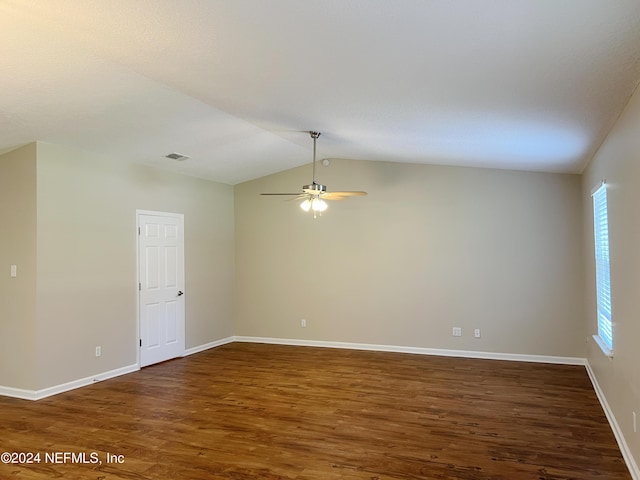 spare room featuring ceiling fan, dark hardwood / wood-style flooring, and vaulted ceiling