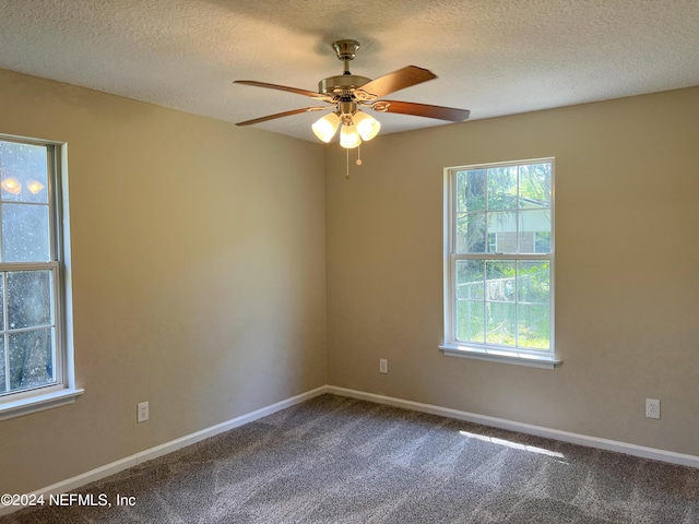 empty room with a textured ceiling, carpet floors, and ceiling fan