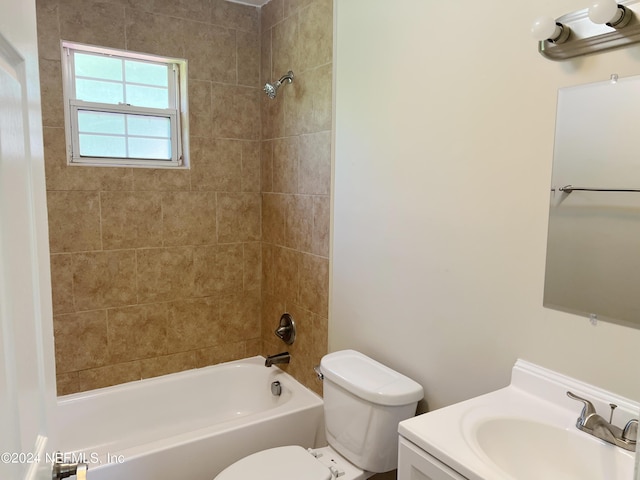 full bathroom featuring toilet, vanity, and tiled shower / bath