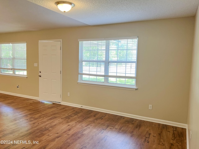 foyer entrance featuring a textured ceiling and hardwood / wood-style flooring