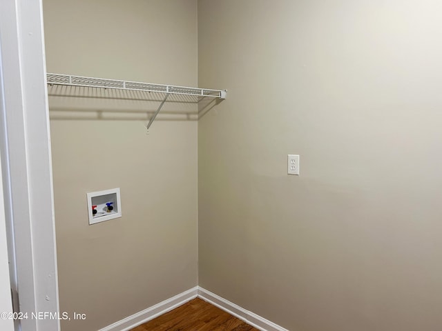 clothes washing area featuring wood-type flooring and hookup for a washing machine