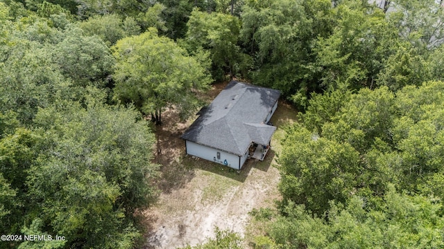 drone / aerial view with a wooded view