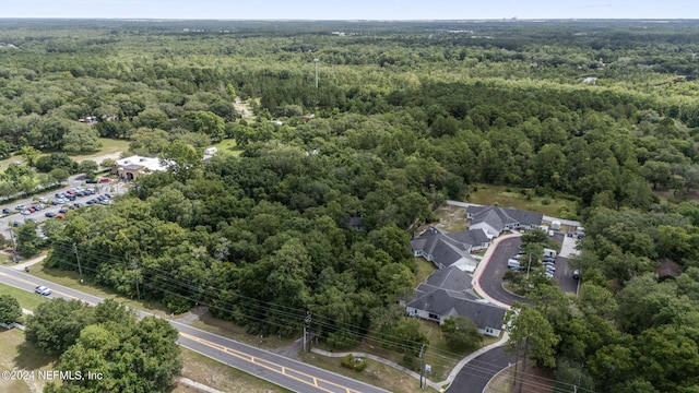 bird's eye view with a wooded view