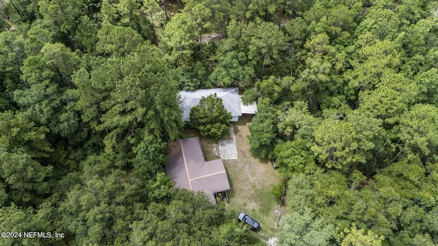 birds eye view of property featuring a view of trees