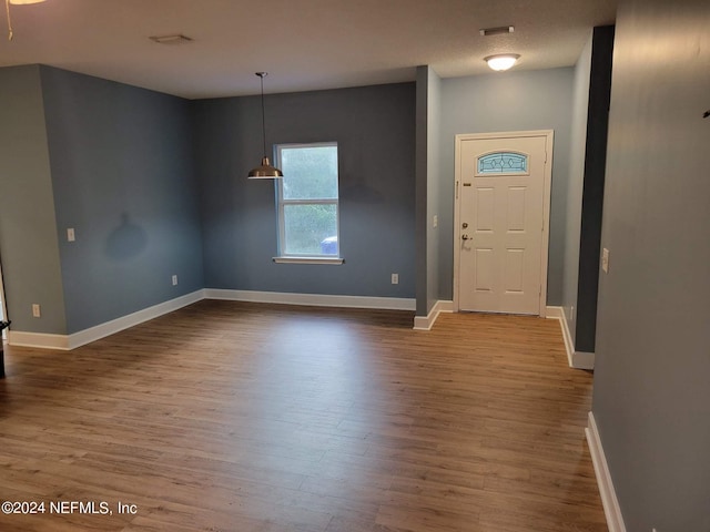 foyer entrance featuring wood-type flooring and a textured ceiling