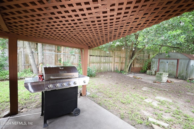 exterior space featuring a grill and a storage shed