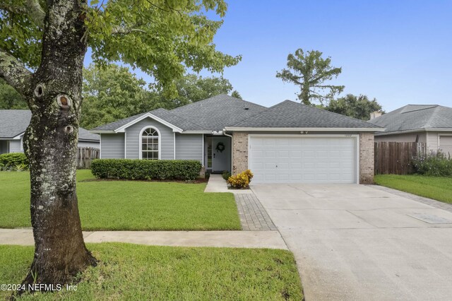 ranch-style house with a front yard and a garage