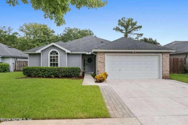 ranch-style home featuring a front yard and a garage